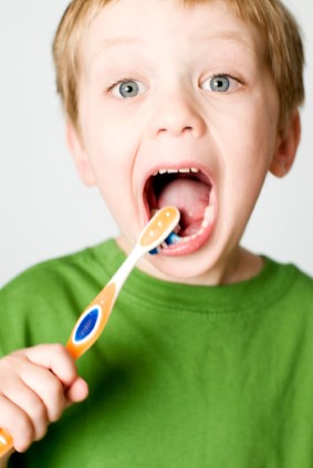 Small child brushing happily